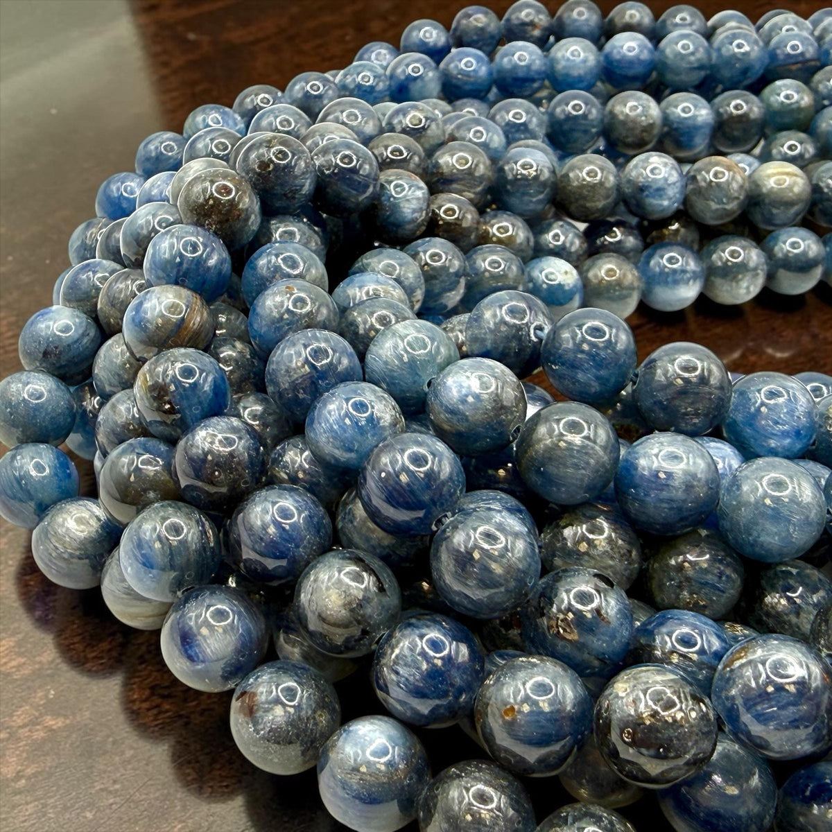 XL smooth round blue kyanite gemstone beads strand with rich ocean blue tones from Brazil